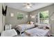 Charming bedroom featuring two twin beds and plenty of natural light from the large window at 2263 Moines Ct, Dunnellon, FL 34431