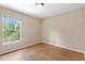 This bedroom features wood floors and a window for natural light at 23340 Nw Columbine Ave, Dunnellon, FL 34431