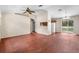 Open living room with a ceiling fan, wood flooring, and natural light from a sliding glass door at 23340 Nw Columbine Ave, Dunnellon, FL 34431
