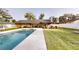 A refreshing backyard view of the swimming pool with covered storage on the side and mature trees at 2441 Se 38Th St, Ocala, FL 34480