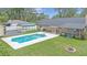 Spacious backyard featuring a refreshing pool, deck area, and well-kept lawn at 2441 Se 38Th St, Ocala, FL 34480