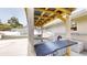 Backyard featuring a wood patio with bar, a carport, and the exterior of the home at 2441 Se 38Th St, Ocala, FL 34480