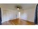 Bright bedroom featuring wood-look flooring, ceiling fan and an abundance of closet space at 2441 Se 38Th St, Ocala, FL 34480