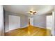 Bright bedroom featuring hardwood floors, ceiling fan, and ensuite bath at 2441 Se 38Th St, Ocala, FL 34480