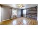 Bedroom with hardwood floors, ceiling fan and a decorative wood accent wall at 2441 Se 38Th St, Ocala, FL 34480