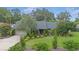 Charming home featuring lush landscaping, mature trees, and a well-manicured lawn at 2441 Se 38Th St, Ocala, FL 34480