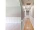Well-lit hallway with board and batten and hardwood floors leading to other rooms at 2441 Se 38Th St, Ocala, FL 34480