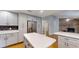 Open kitchen layout with stainless steel appliances and a large island with quartz countertop at 2441 Se 38Th St, Ocala, FL 34480