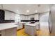 Bright kitchen with stainless steel appliances, quartz countertops, and stylish black and gold backsplash at 2441 Se 38Th St, Ocala, FL 34480