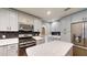 Kitchen features stainless steel appliances, sleek gray cabinetry, and center island at 2441 Se 38Th St, Ocala, FL 34480