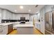 Updated kitchen with stainless steel appliances, white cabinets, and center island with quartz countertop at 2441 Se 38Th St, Ocala, FL 34480