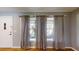 Bright living room with hardwood floors, large windows, and neutral-colored curtains at 2441 Se 38Th St, Ocala, FL 34480