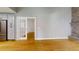 Open-concept living room with a brick fireplace, leading to a modern kitchen through french doors at 2441 Se 38Th St, Ocala, FL 34480