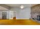 Open-concept living room with a brick fireplace, leading to a modern kitchen through french doors at 2441 Se 38Th St, Ocala, FL 34480