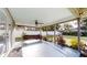 Covered back porch featuring a painted concrete floor, ceiling fan, and swing at 2441 Se 38Th St, Ocala, FL 34480