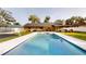 Backyard showcasing a sparkling swimming pool with a view of the covered storage and sheds at 2441 Se 38Th St, Ocala, FL 34480