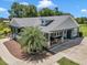 Bird's-eye view of a home showing the front yard, exterior finishes, and landscaped surrounding at 300 Se Highway 42, Summerfield, FL 34491