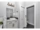 Elegant bathroom with a vanity, modern fixtures, and a door to a separate toilet area at 300 Se Highway 42, Summerfield, FL 34491