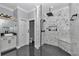 Modern bathroom with a luxurious walk-in shower featuring marble tile, a rainfall showerhead, and a built-in bench at 300 Se Highway 42, Summerfield, FL 34491