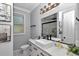 Bright, updated bathroom with hexagon tile floor, marble vanity and modern fixtures at 300 Se Highway 42, Summerfield, FL 34491
