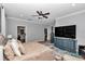 Bedroom with a ceiling fan, wood-look floors, dresser, upholstered bed, and an ensuite bathroom at 300 Se Highway 42, Summerfield, FL 34491