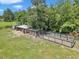View of expansive chicken coop area on the property with mature trees surrounding the structure at 300 Se Highway 42, Summerfield, FL 34491