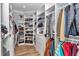 Organized walk-in closet with built-in shelving, drawers, and ample hanging space for clothes and accessories at 300 Se Highway 42, Summerfield, FL 34491