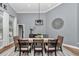 Elegant dining area featuring a modern chandelier, a large table, and comfortable seating, perfect for Gathering meals at 300 Se Highway 42, Summerfield, FL 34491