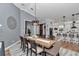 Open-concept dining area connecting to a stylish kitchen, featuring modern lighting, a spacious table, and comfortable seating at 300 Se Highway 42, Summerfield, FL 34491