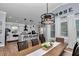 Bright dining area with a modern chandelier, a spacious table, and an open view of the stylish kitchen at 300 Se Highway 42, Summerfield, FL 34491