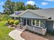 Beautiful home with a well-maintained yard and a welcoming front porch with decorative details at 300 Se Highway 42, Summerfield, FL 34491