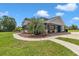 Inviting single-story home with a covered porch, walkway, manicured landscaping, and a charming curb appeal at 300 Se Highway 42, Summerfield, FL 34491