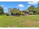 A cozy single-story home with a manicured lawn, landscaping, and a charming exterior design at 300 Se Highway 42, Summerfield, FL 34491