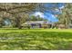 A single-story home with mature trees, and a spacious front yard at 300 Se Highway 42, Summerfield, FL 34491