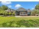 Charming single-story home with a well-manicured lawn, mature trees, and inviting front porch at 300 Se Highway 42, Summerfield, FL 34491