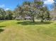 A single-story home with mature trees, and spacious front yard at 300 Se Highway 42, Summerfield, FL 34491