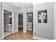 Hallway featuring wood flooring and doorways into a bathroom, a bedroom, and a closet at 300 Se Highway 42, Summerfield, FL 34491