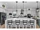 Modern kitchen with a large center island, breakfast bar, stainless steel appliances, and pendant lighting at 300 Se Highway 42, Summerfield, FL 34491