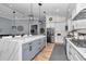 Bright kitchen with white cabinets, marble countertops, stainless steel appliances, and a spacious island at 300 Se Highway 42, Summerfield, FL 34491