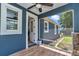 Cozy screened lanai featuring wood-look tile flooring and views of the backyard at 300 Se Highway 42, Summerfield, FL 34491