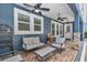 Inviting lanai featuring comfortable seating, ceiling fans, and a relaxing atmosphere for outdoor enjoyment at 300 Se Highway 42, Summerfield, FL 34491
