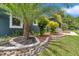 Close up of the rock wall and the landscaping around the house at 300 Se Highway 42, Summerfield, FL 34491