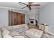 Cozy living room with a stone fireplace, plush seating, and modern decor, perfect for relaxing and entertaining at 300 Se Highway 42, Summerfield, FL 34491
