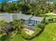 Beautiful aerial view of the home with a deck, lush greenery, and manicured landscaping at 3000 Pine Grove Ln, Lady Lake, FL 32159