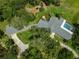 Aerial view of a home featuring a screened pool, extensive landscaping, and mature trees at 3000 Pine Grove Ln, Lady Lake, FL 32159