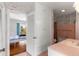 Retro bathroom with pink tiles, shower-tub combo, and built-in storage near a bedroom at 3000 Pine Grove Ln, Lady Lake, FL 32159