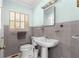 Classic bathroom with gray tiles, pedestal sink, and window with shutter blinds at 3000 Pine Grove Ln, Lady Lake, FL 32159
