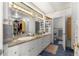 Bathroom featuring a double vanity, neutral walls, ample storage and a walk-in closet at 3000 Pine Grove Ln, Lady Lake, FL 32159