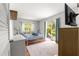 Cozy bedroom with hardwood floors, plenty of natural light, and a sliding glass door to the backyard at 3000 Pine Grove Ln, Lady Lake, FL 32159