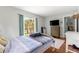 Bright bedroom with light hardwood floors, natural light, and a serene view of the backyard at 3000 Pine Grove Ln, Lady Lake, FL 32159